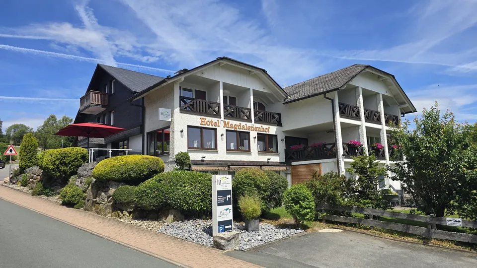 Hotel Magdalenenhof von der Straße Zum Hohen Eimberg aus, mit Blumen und Hinweisschild